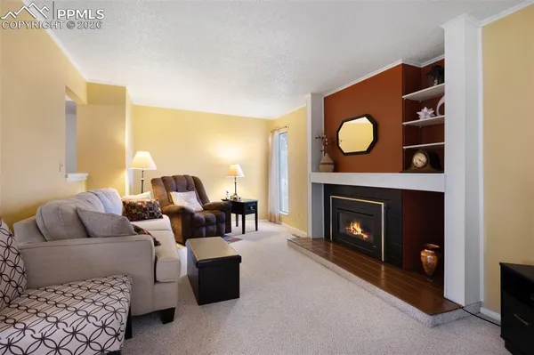 a living room with furniture and a fireplace