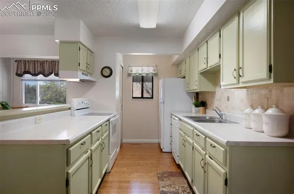 a kitchen with a sink stove and cabinets