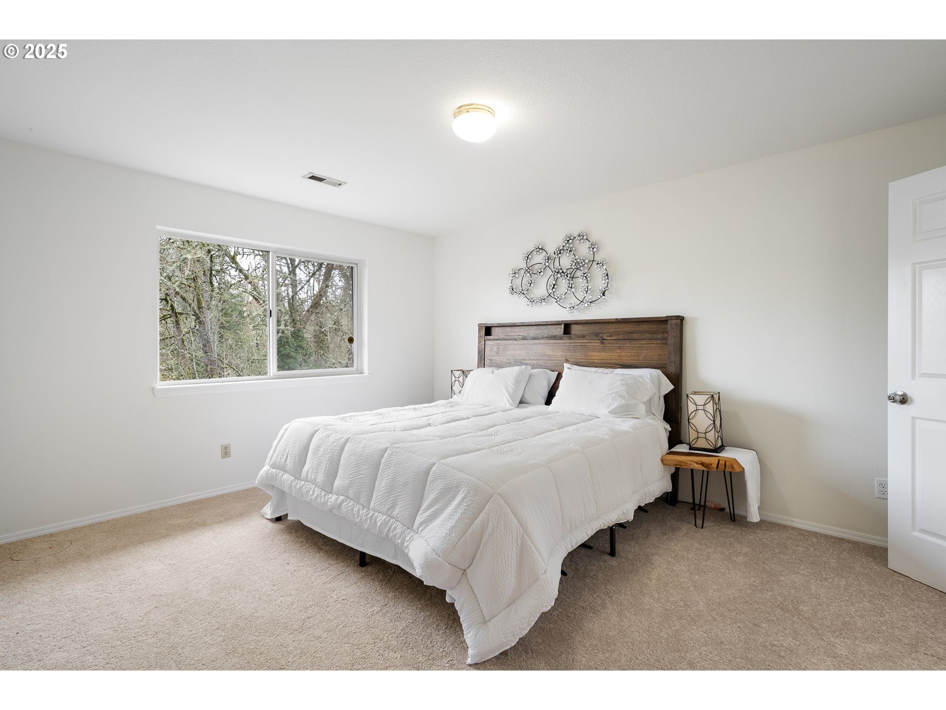 16033 Northwest Ridgetop Lane Beaverton, OR 97006 - Photo 13 of 42 a bedroom with a bed and window