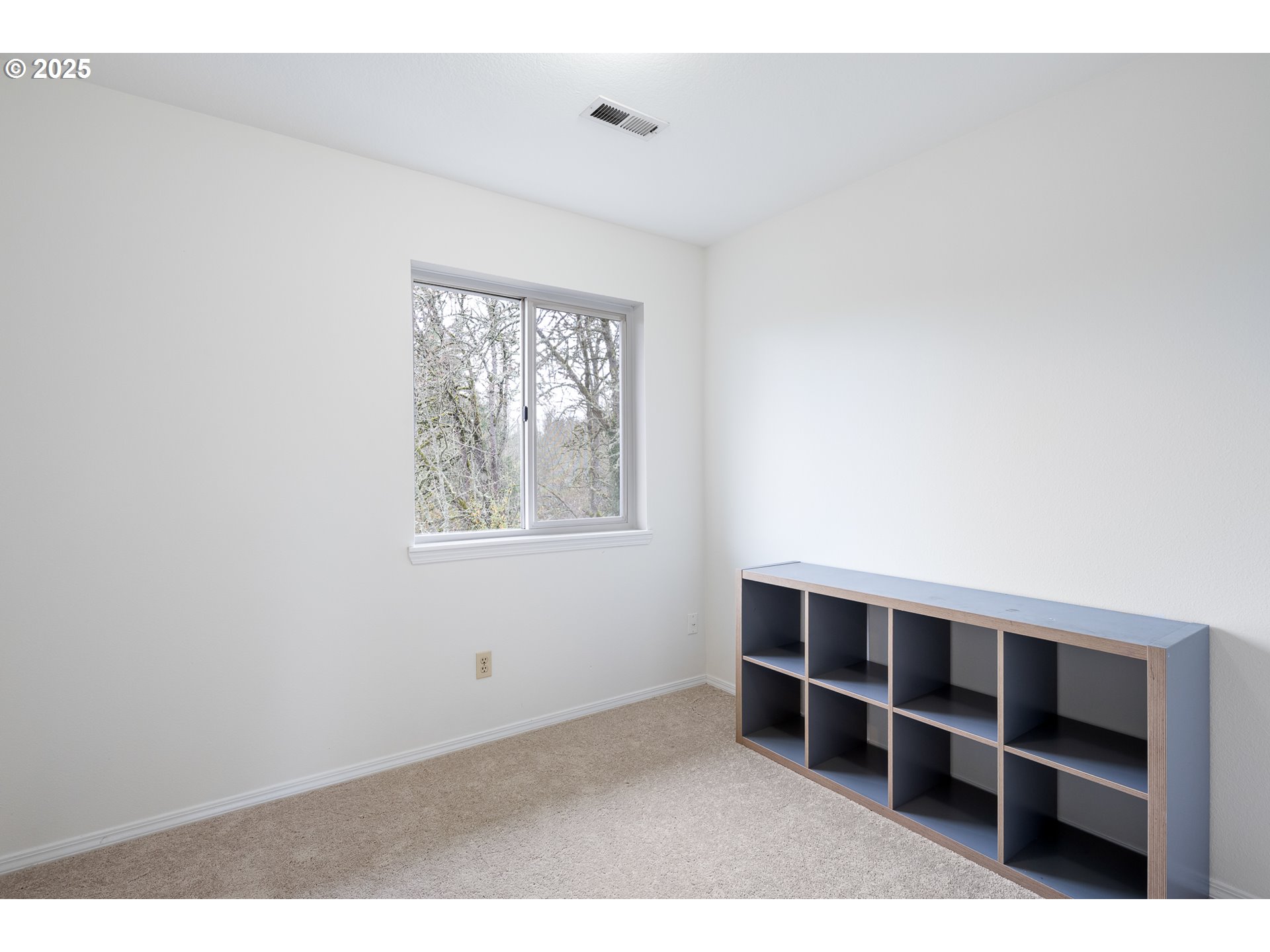 16033 Northwest Ridgetop Lane Beaverton, OR 97006 - Photo 22 of 42 a view of an empty room with empty shelves