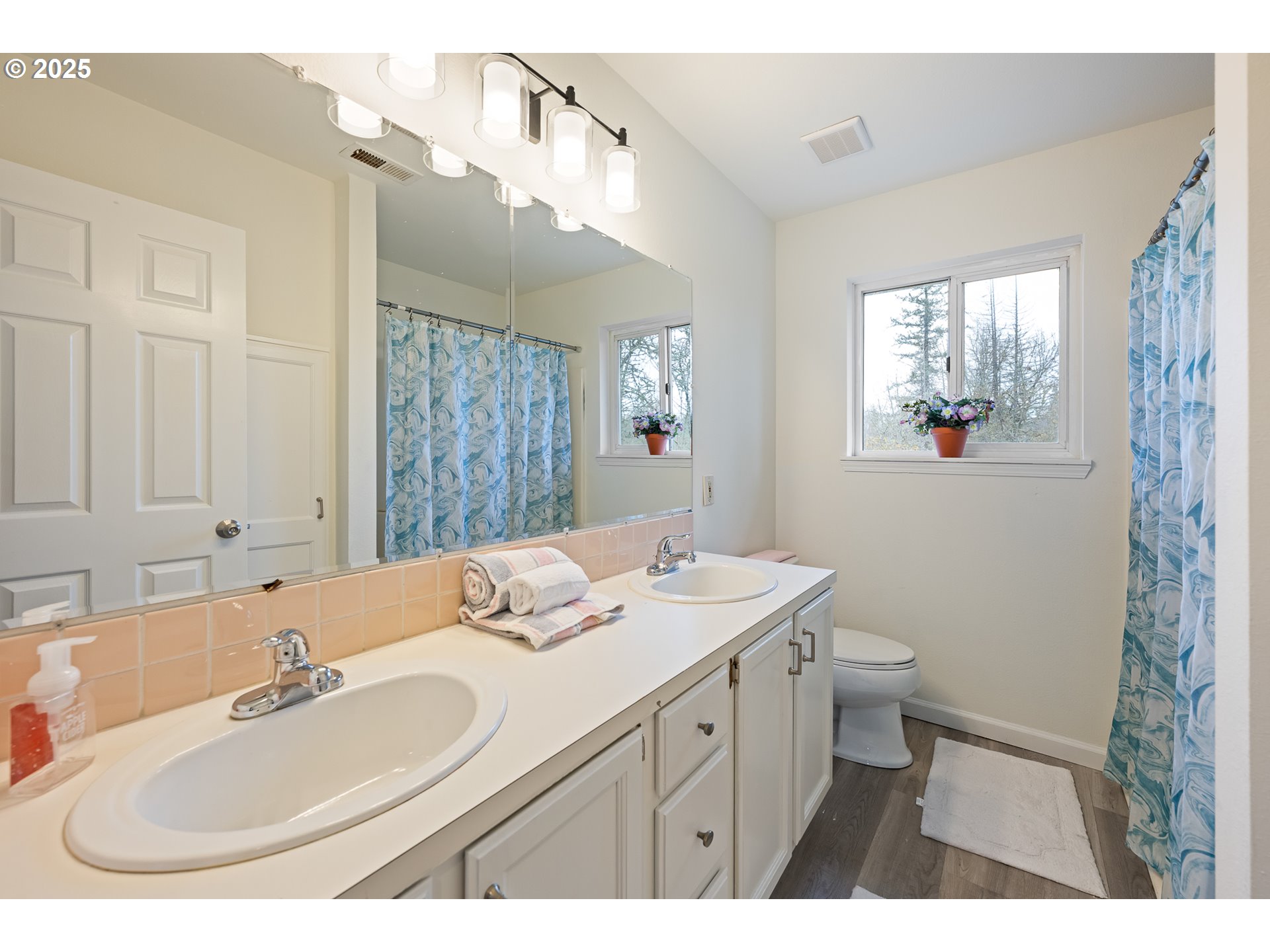 16033 Northwest Ridgetop Lane Beaverton, OR 97006 - Photo 24 of 42 a bathroom with a sink and a mirror
