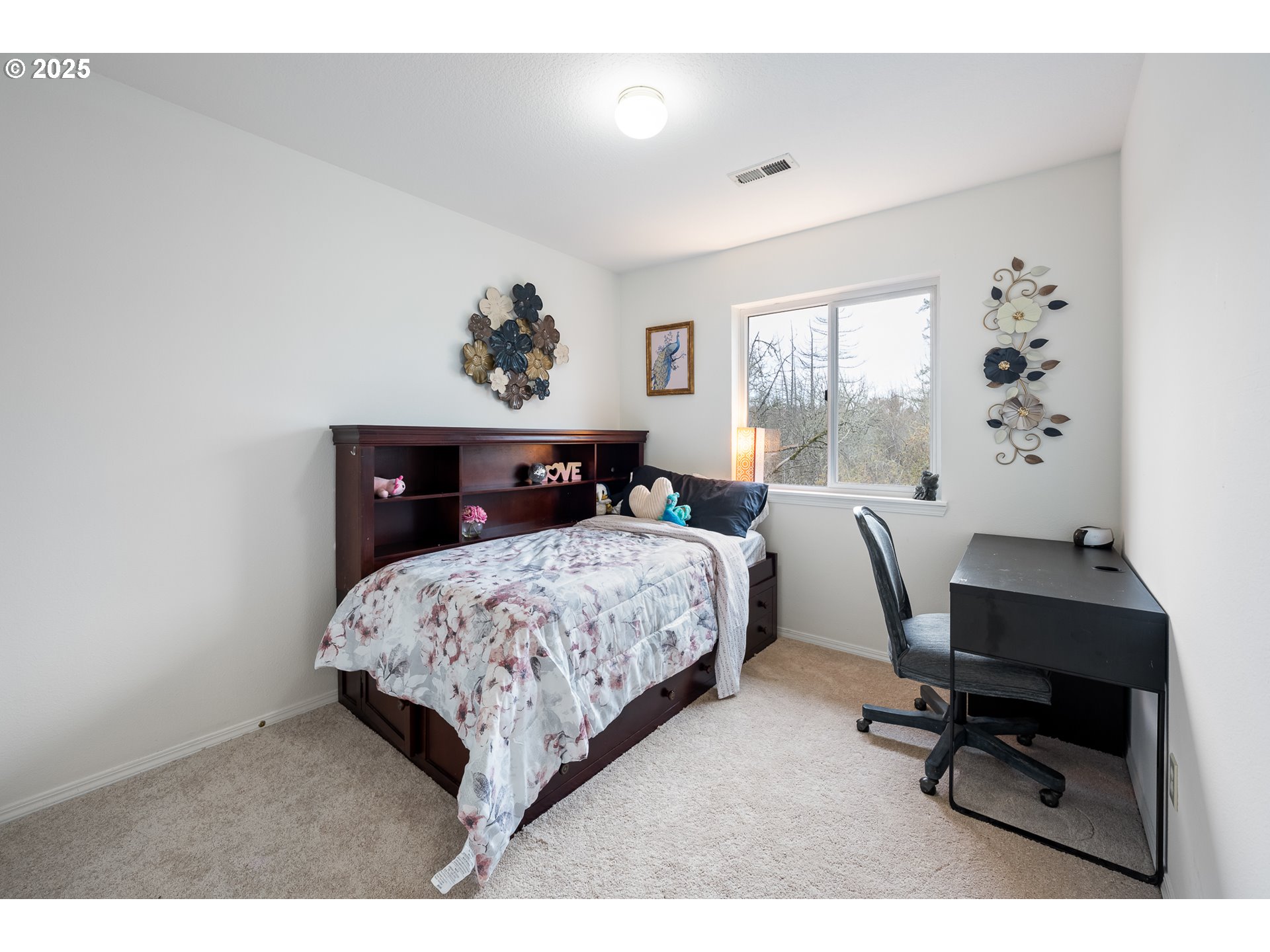 16033 Northwest Ridgetop Lane Beaverton, OR 97006 - Photo 25 of 42 a bedroom with a bed a desk and chair with window