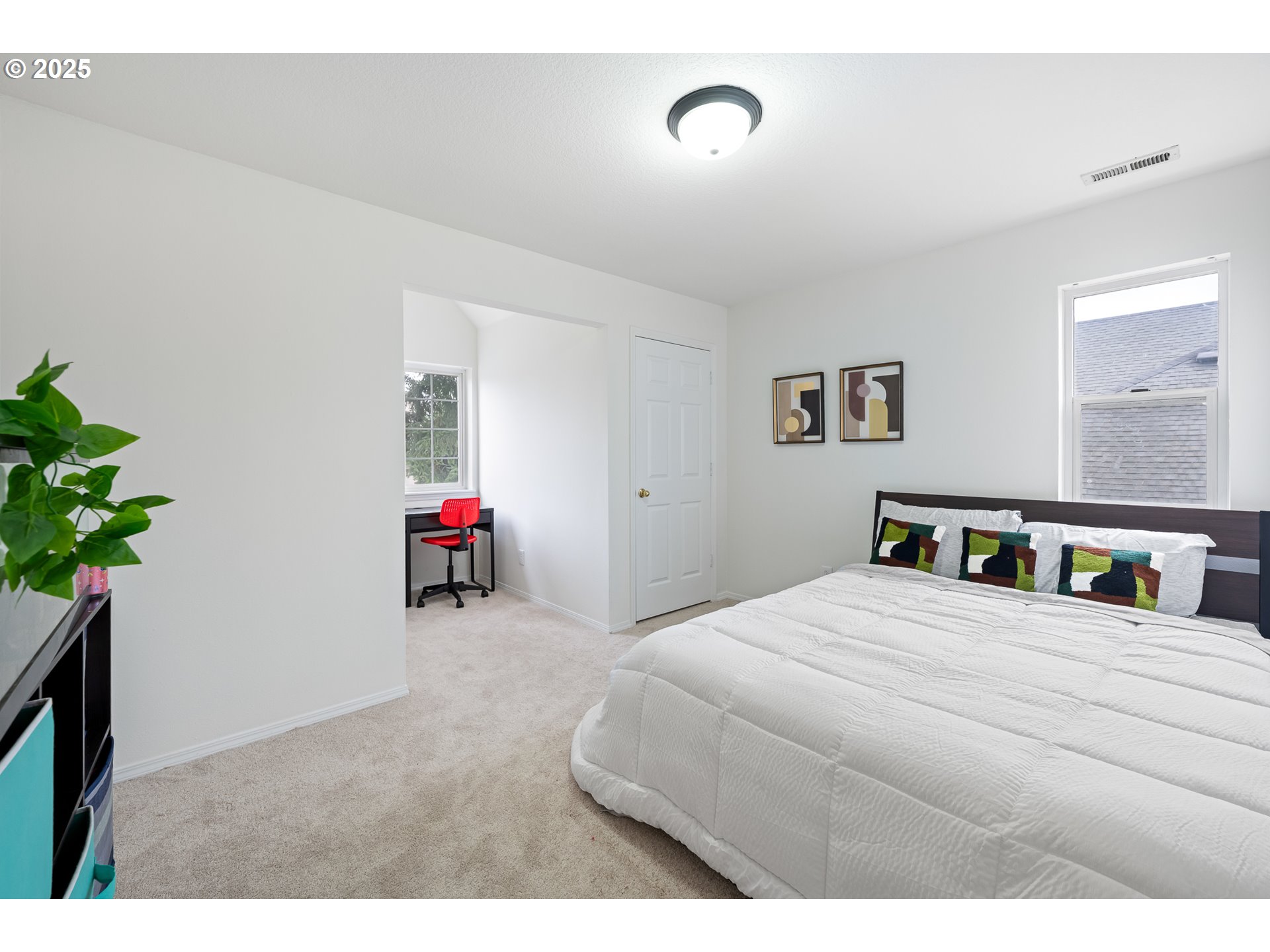 16033 Northwest Ridgetop Lane Beaverton, OR 97006 - Photo 26 of 42 a bedroom with a bed and a potted plant