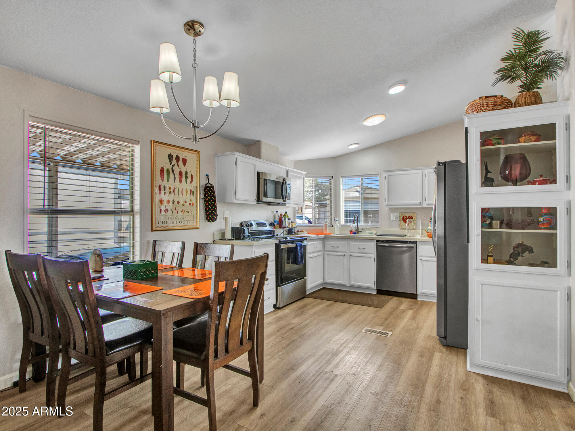 6227 North Litchfield Road, Unit 69 Litchfield Park, AZ 85340 - Photo 10 of 30 a view of a dining room with furniture and wooden floor