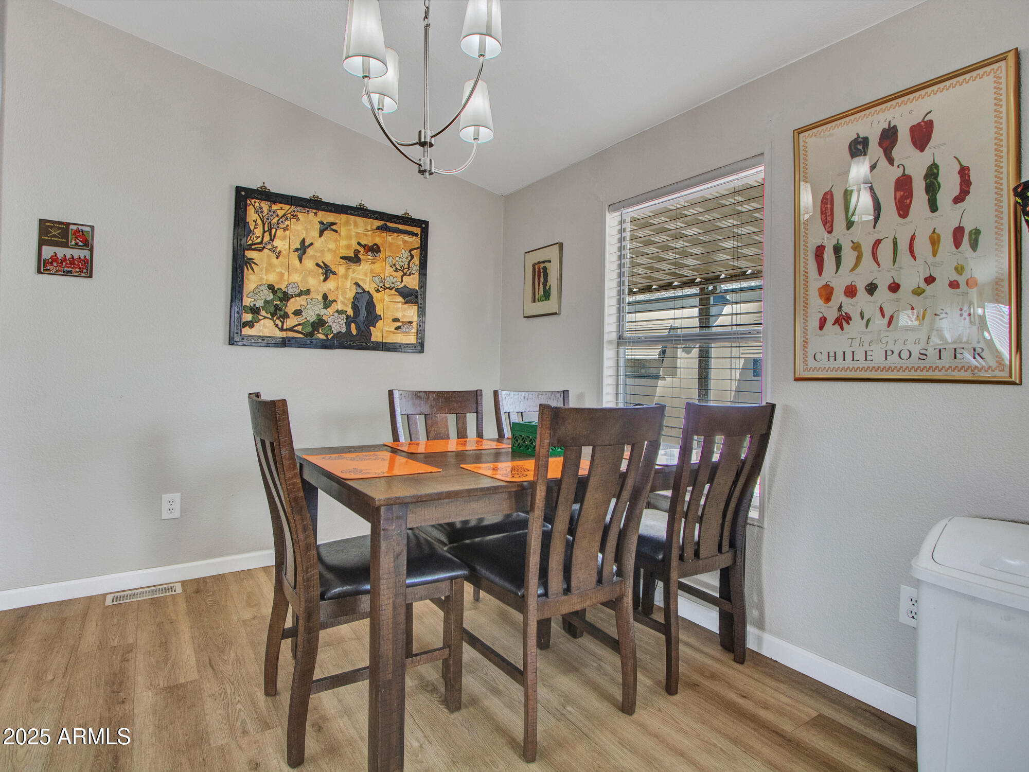 6227 North Litchfield Road, Unit 69 Litchfield Park, AZ 85340 - Photo 11 of 30 a view of a dining room with furniture wooden floor and a chandelier