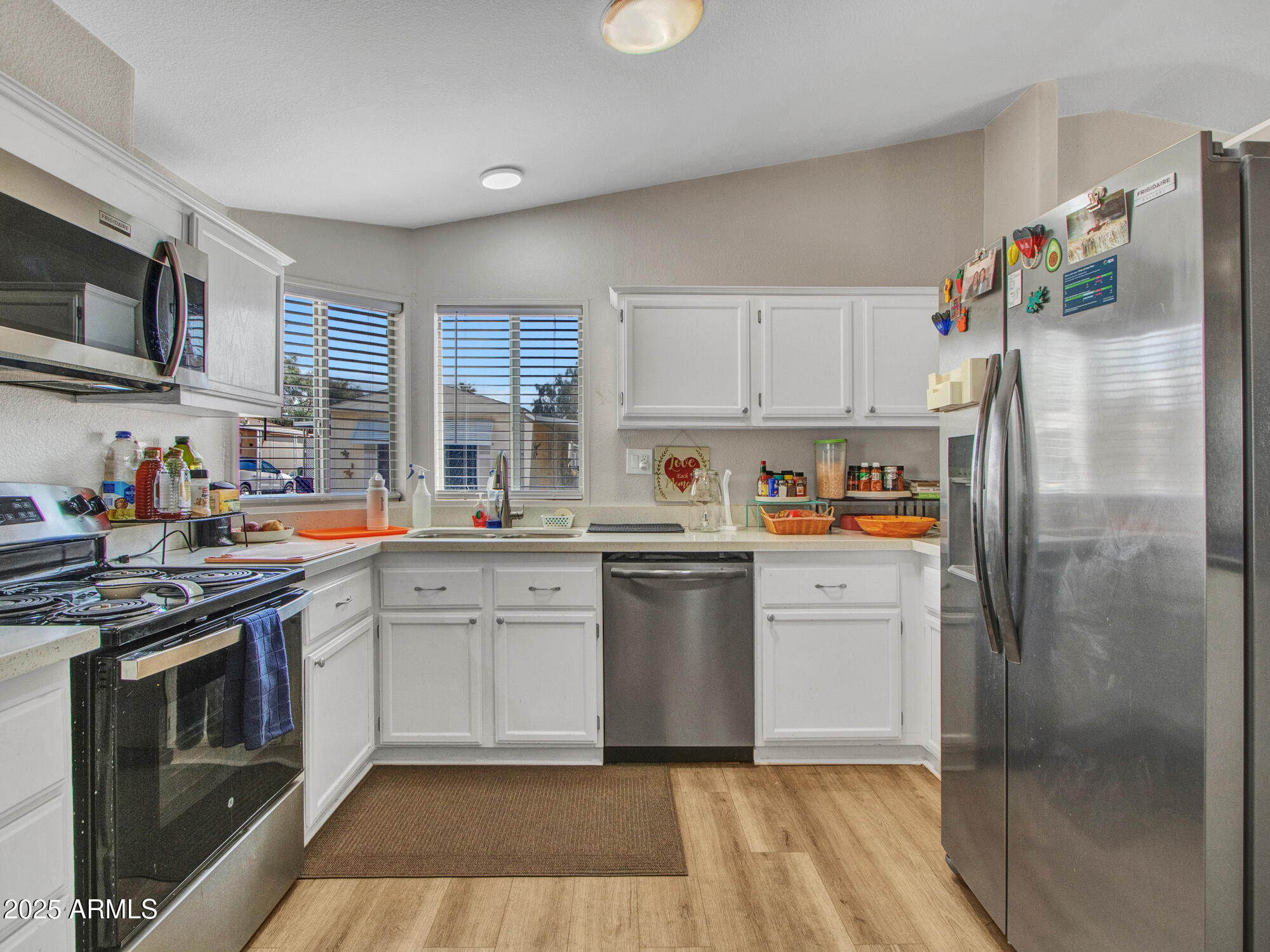 6227 North Litchfield Road, Unit 69 Litchfield Park, AZ 85340 - Photo 12 of 30 a kitchen with a refrigerator sink and cabinets
