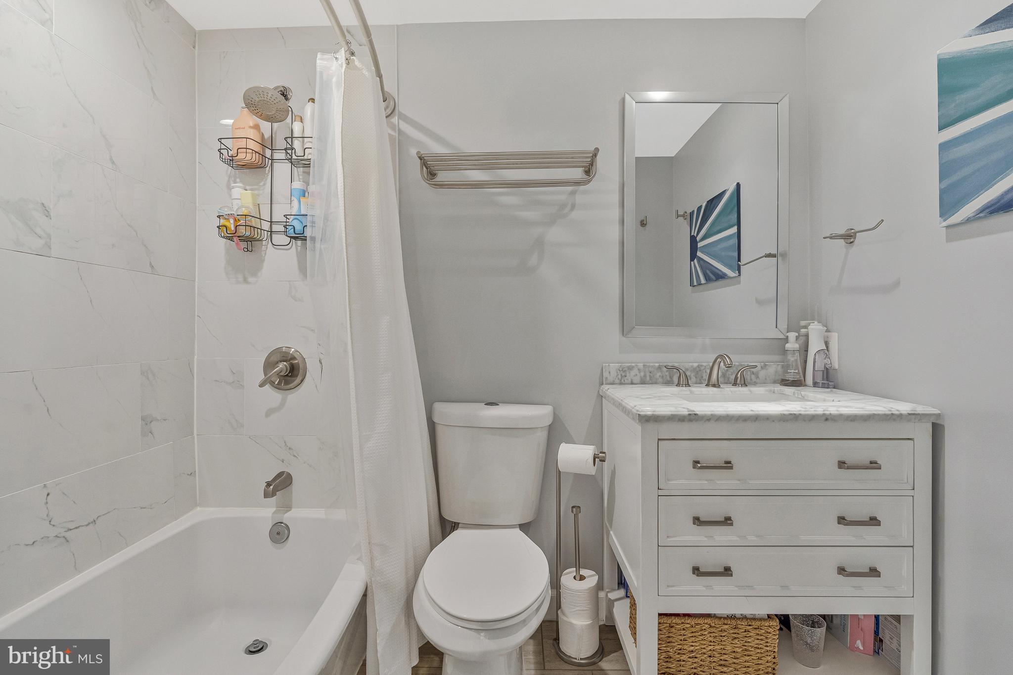 11046 Granby Court Reston, VA 20191 - Photo 21 of 43 a bathroom with a granite countertop toilet a sink and a bathtub