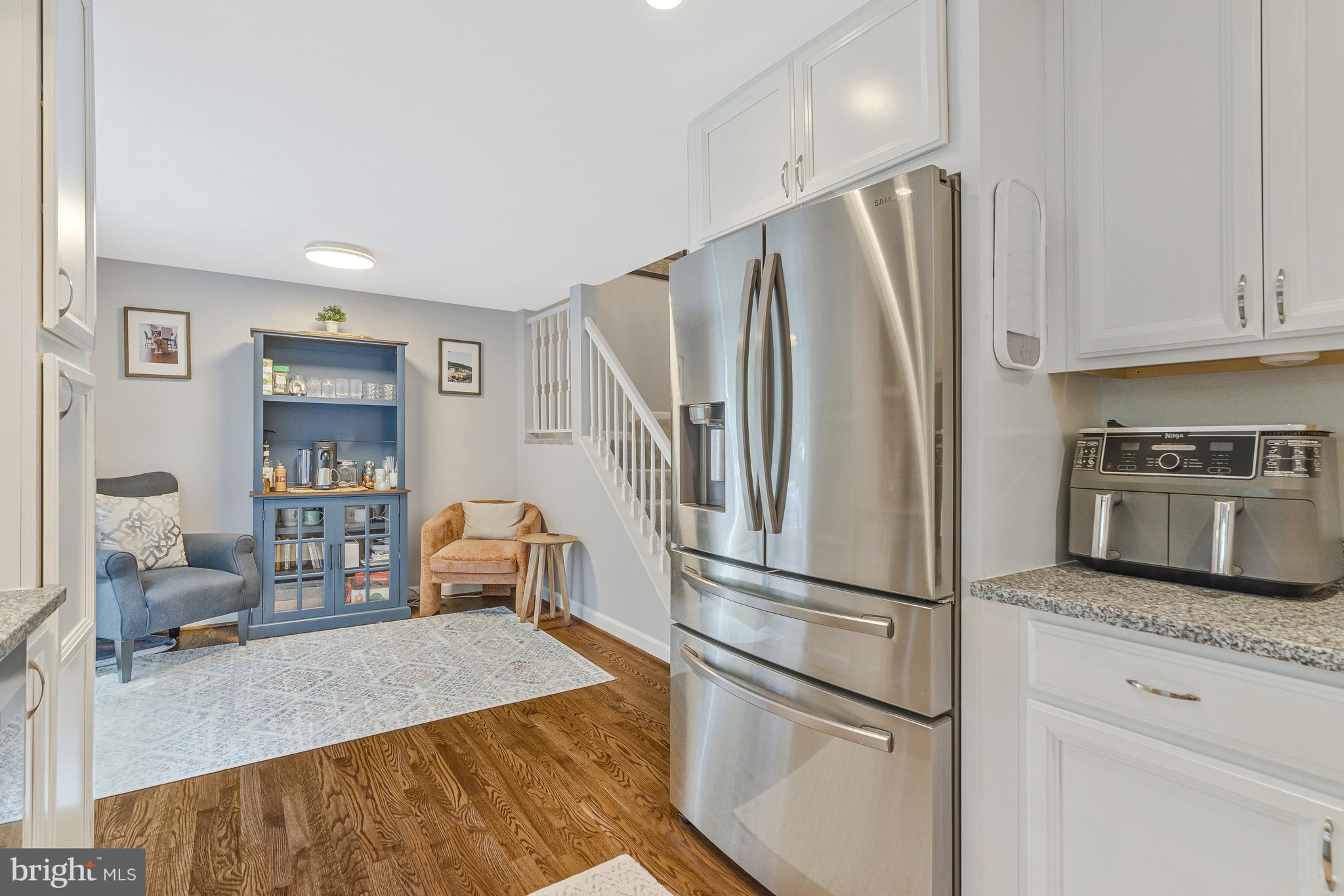 11046 Granby Court Reston, VA 20191 - Photo 3 of 43 a kitchen with kitchen island a counter top space wooden floor and stainless steel appliances