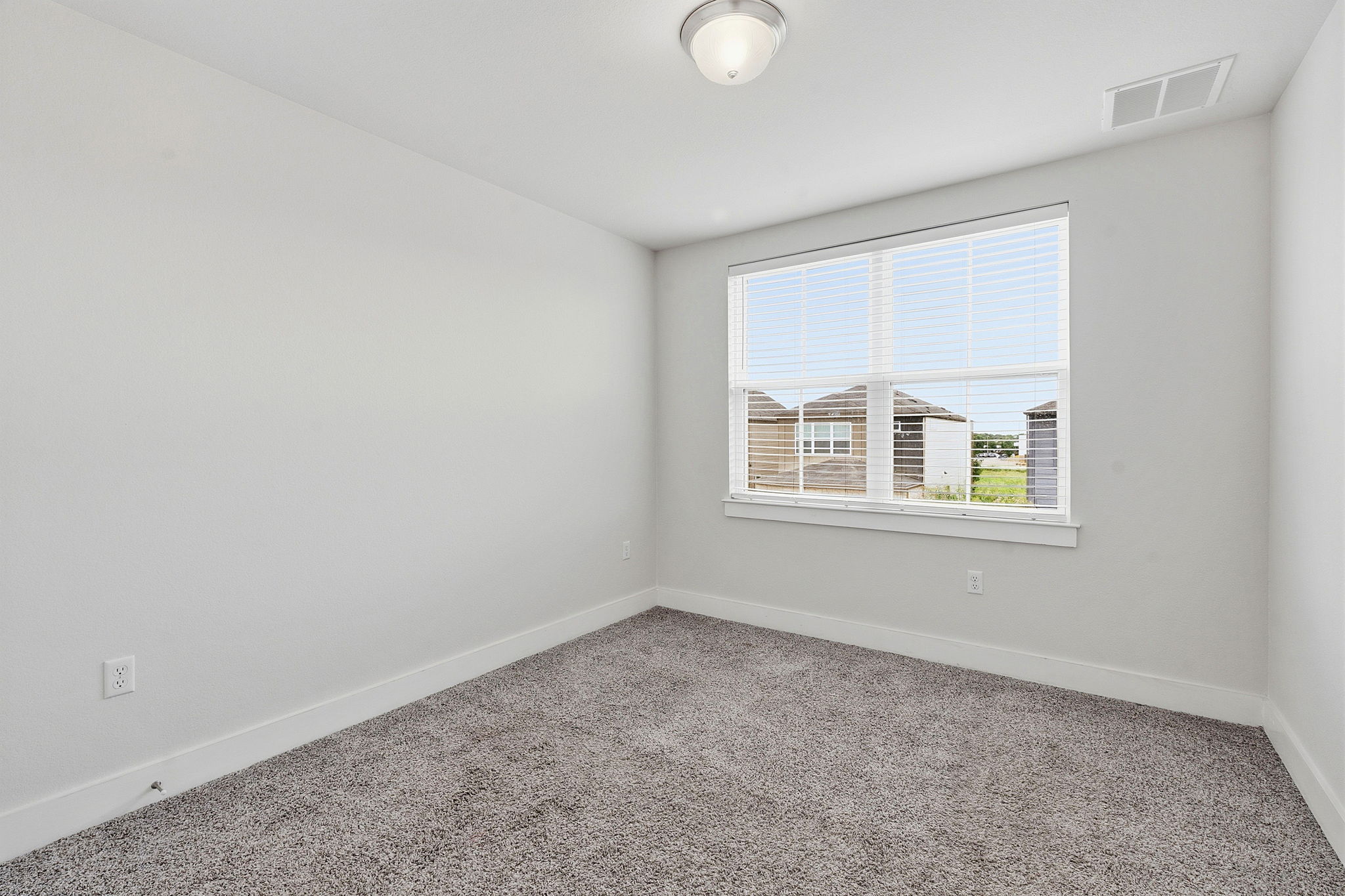 7105 Silver Star Lane, Unit 59 Austin, TX 78744 - Photo 13 of 19 an empty room with windows