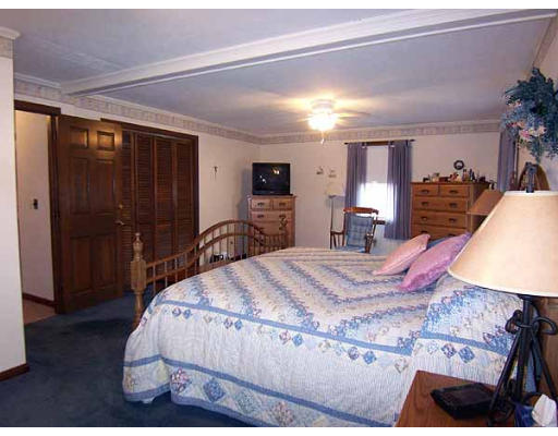 49 Dutchess Street Springfield, MA 01129 - Photo 13 of 25 a bed room with a bed and a mirror