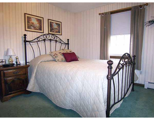 49 Dutchess Street Springfield, MA 01129 - Photo 16 of 25 a bedroom with a bed and a chandelier