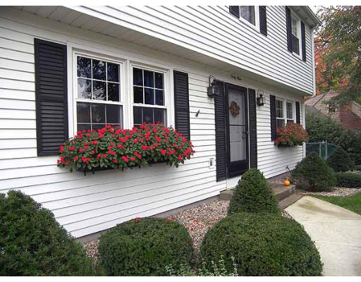 49 Dutchess Street Springfield, MA 01129 - Photo 24 of 25 a front view of a house with a yard and potted plants