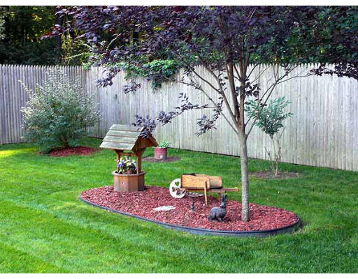49 Dutchess Street Springfield, MA 01129 - Photo 25 of 25 a view of a backyard with table and chairs potted plants and wooden fence