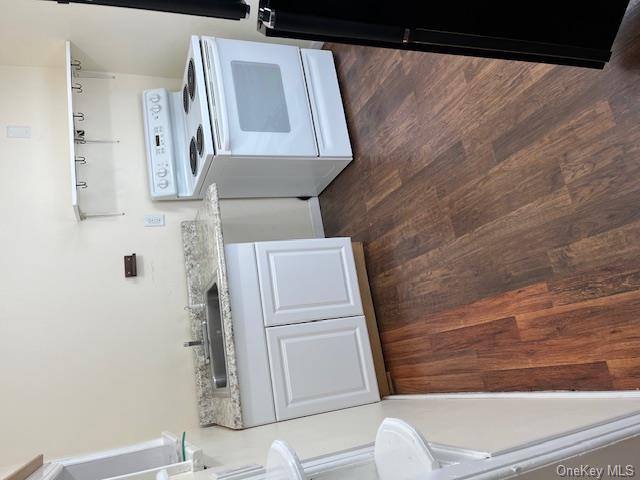 177 South Plank Road, Unit #2 Newburgh, NY 12550 - Photo 2 of 6 Kitchen featuring white cabinetry, light stone countertops, sink, dark hardwood / wood-style floors, and stove