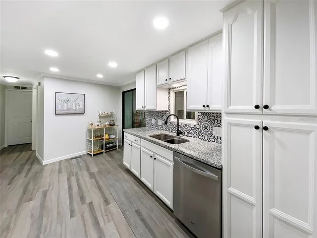 a view of a house with a large window and a yard with stairs
