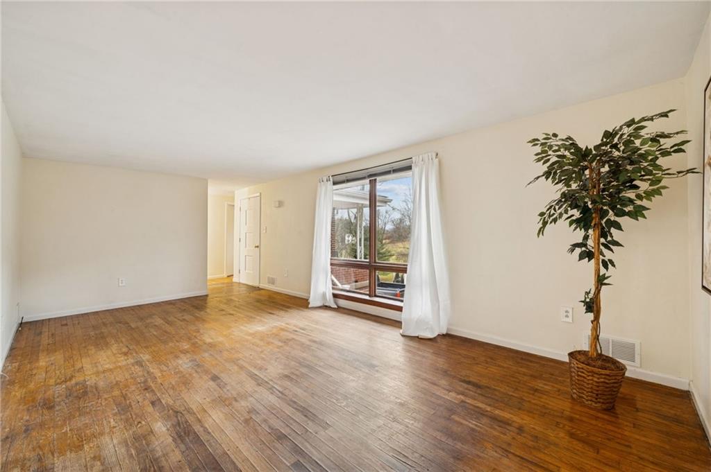 116 Grange Road Greensburg, PA 15601 - Photo 3 of 29 an empty room with wooden floor and windows
