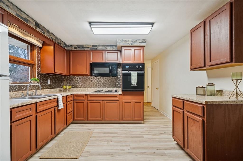 116 Grange Road Greensburg, PA 15601 - Photo 7 of 29 a kitchen with stainless steel appliances granite countertop a sink stove and cabinets