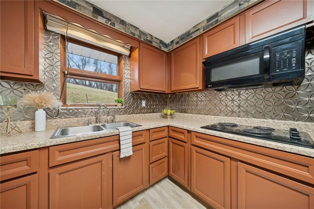 116 Grange Road Greensburg, PA 15601 - Photo 8 of 29 a kitchen with stainless steel appliances granite countertop a sink stove and microwave