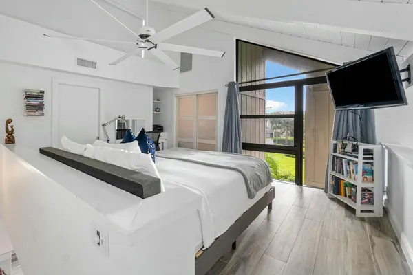 a bedroom with a bed and a flat screen tv