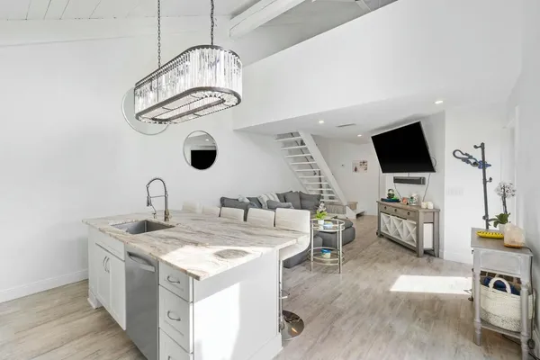 a view of living room with granite countertop furniture and a flat screen tv