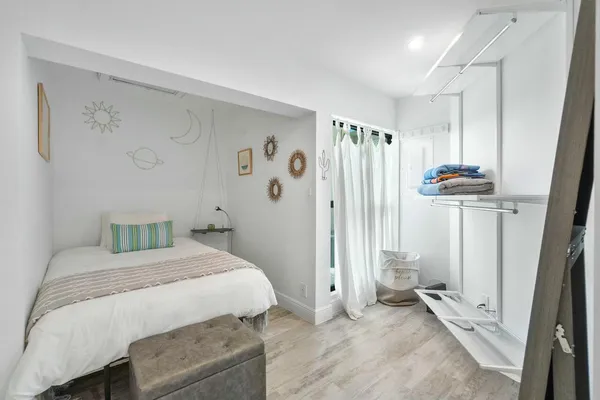 a bedroom with a bed and a window