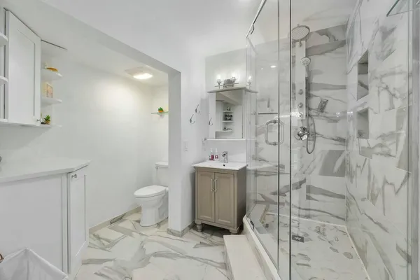 a bathroom with a shower toilet and sink