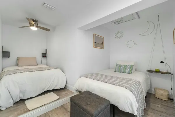 a bedroom with a bed and wooden floor