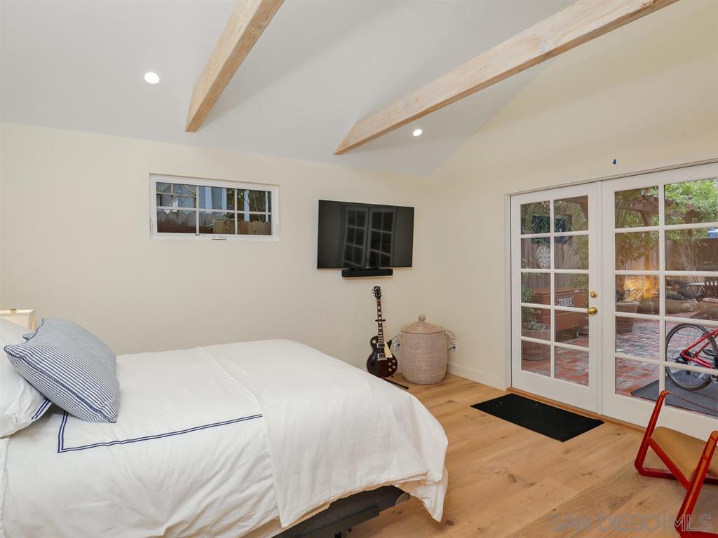 253 26th Street Del Mar, CA 92014 - Photo 16 of 22 a bedroom with a bed and a flat screen tv