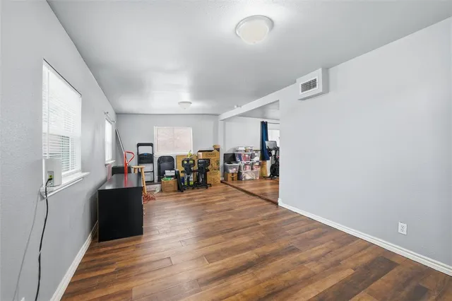 a view of a livingroom with hardwood floor and a ceiling fan