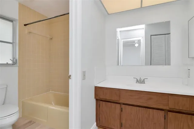 a bathroom with a sink toilet and a mirror