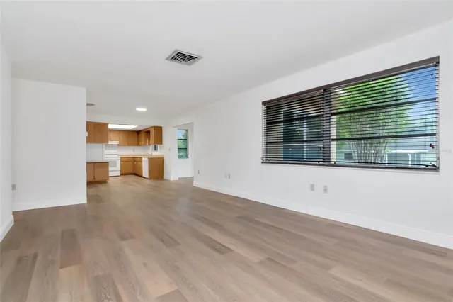 a view of kitchen with wooden floor and electronic appliances