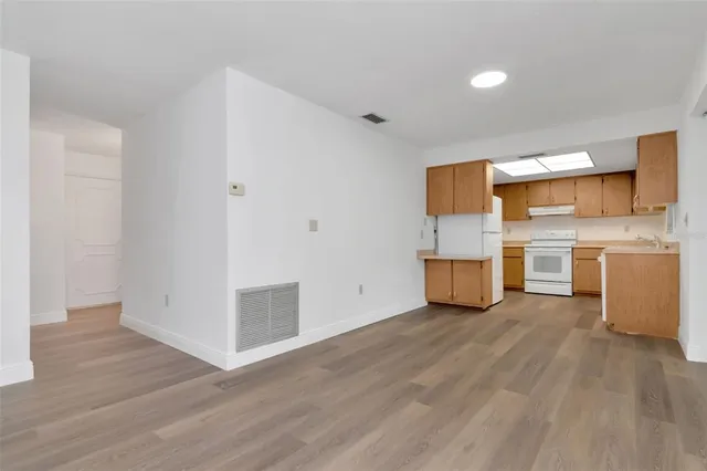 a kitchen with a sink a stove a refrigerator and cabinets