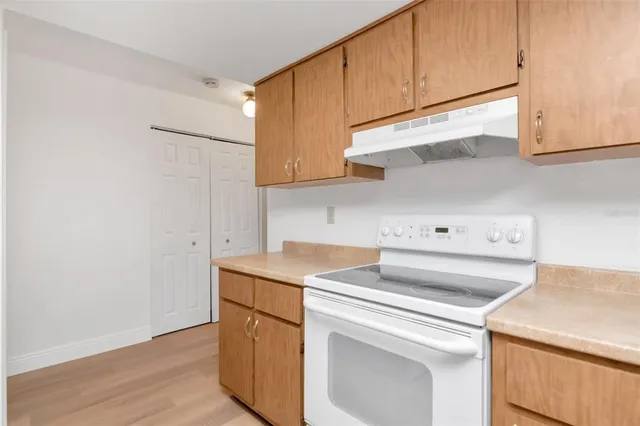 a kitchen with a sink cabinets and window