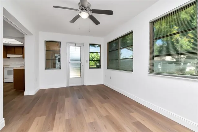 a kitchen with stainless steel appliances granite countertop a sink and a cabinets with wooden floor