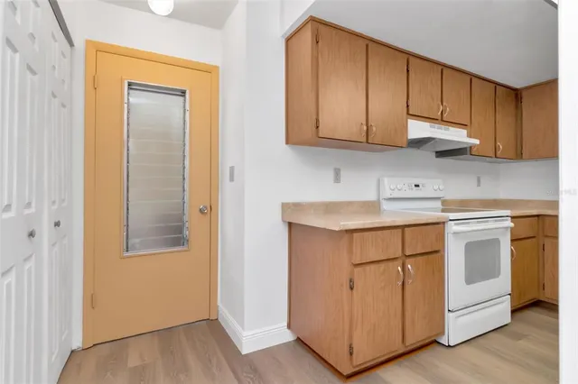 a view of house with garden and trees