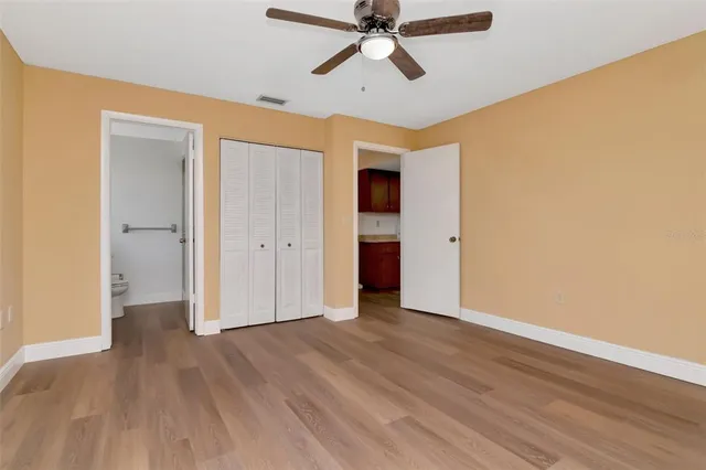 a view of empty room with wooden floor