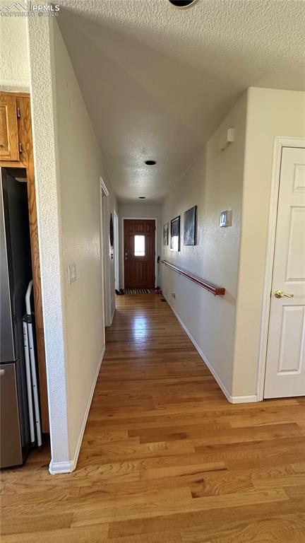 198 Luxury Lane Colorado Springs, CO 80921 - Photo 21 of 34 a view of a hallway with wooden floor and staircase