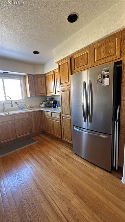 198 Luxury Lane Colorado Springs, CO 80921 - Photo 4 of 34 a kitchen with stainless steel appliances granite countertop a refrigerator a sink and a stove
