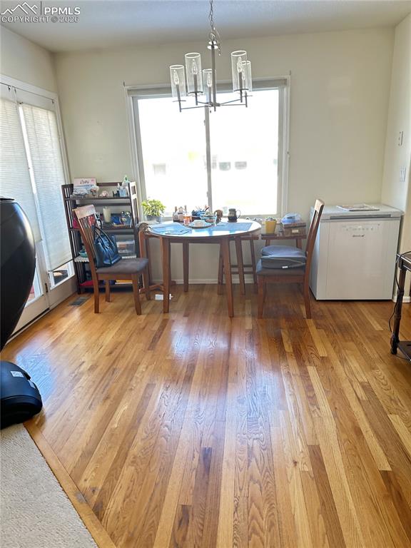 198 Luxury Lane Colorado Springs, CO 80921 - Photo 5 of 34 a living room with dining room and wooden floor