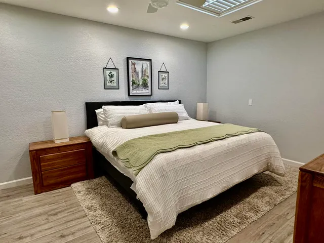 a bedroom with a bed and a desk