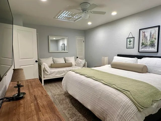 a bedroom with a bed and a chandelier