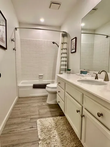 a bathroom with a sink toilet and shower
