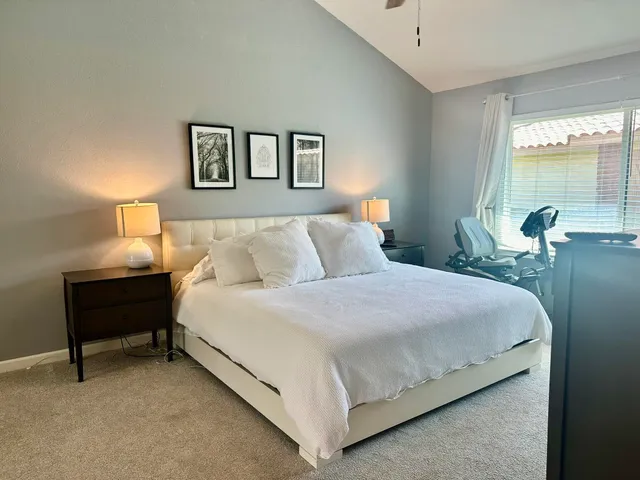 a bedroom with a bed and window