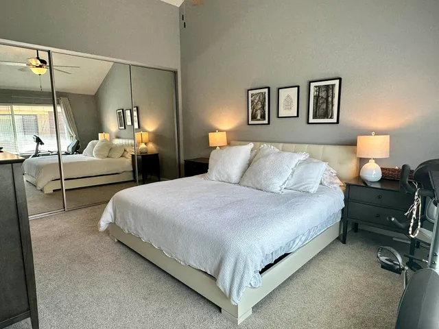 a bedroom with a bed and lamp