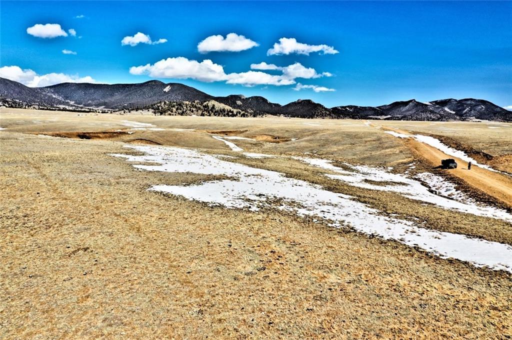 5251 Mesa Road Hartsel, CO 80449 - Photo 8 of 9 a view of a lake with a mountain