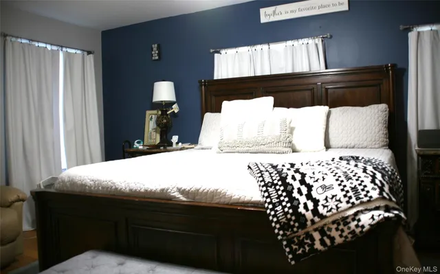 a bedroom with a bed and window