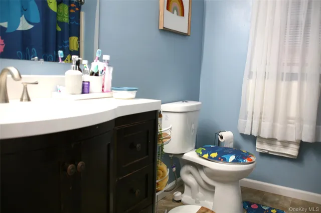 a bathroom with a sink toilet and a mirror
