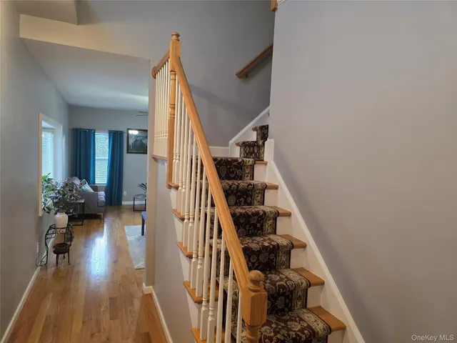en view of entryway and hall with wooden floor
