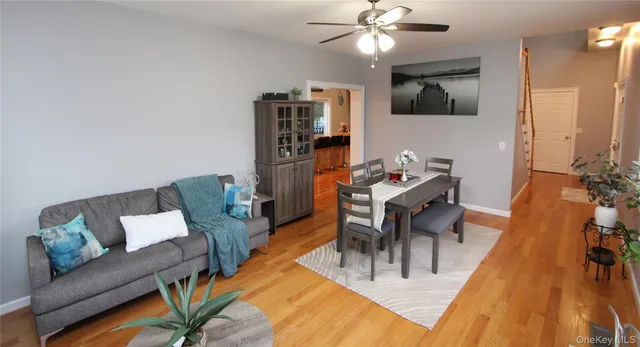 a dining room with furniture and wooden floor