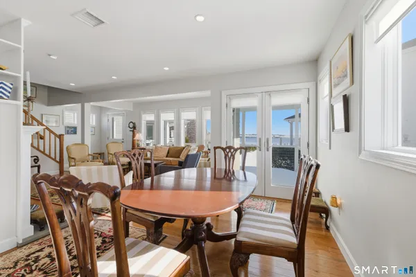 a view of a dining room with furniture and a potted plant